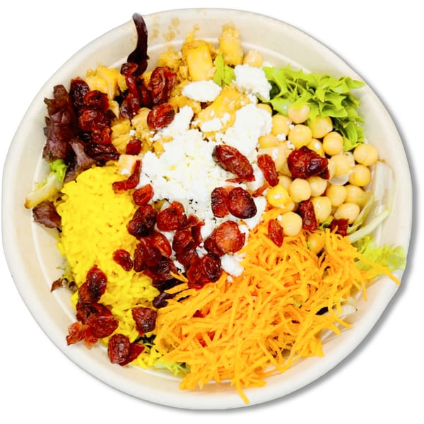 A vibrant Salad Fox bowl with yellow rice, chickpeas, cranberries, shredded carrots, and feta cheese.